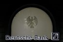 The logo of Germany's largest business bank, Deutsche Bank, is illuminated at the bank's original headquarters in Frankfurt