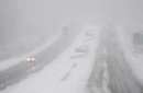 Traffic moves in the U.S. 41 By-Pass in Henderson, Ky., Wednesday, Dec. 26, 2012 as a snow storm moves through the area making travel treacherous. (AP Photo/The Gleaner, Mike Lawrence)